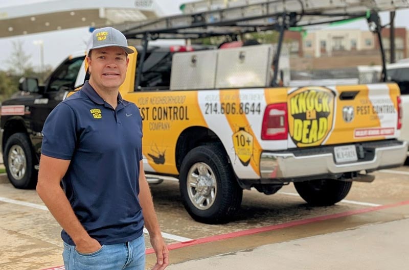 Tucker Epsy, owner of Knock Em Dead Pest Control, standing beside the company service truck